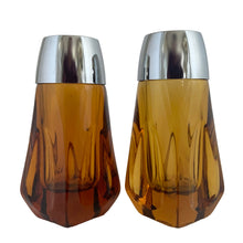 Load image into Gallery viewer, Vintage atomic amber glass salt and pepper shakers with plasticized chrome lids. Crafted by Libbey Glass, 1960s. Add this classic to your tableware collection!

In excellent condition, no chips.

Measures 1 5/8 x 1 5/8 x 4 1/8 inches
