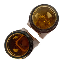 Load image into Gallery viewer, Vintage atomic amber glass salt and pepper shakers with plasticized chrome lids. Crafted by Libbey Glass, 1960s. Add this classic to your tableware collection!

In excellent condition, no chips.

Measures 1 5/8 x 1 5/8 x 4 1/8 inches
