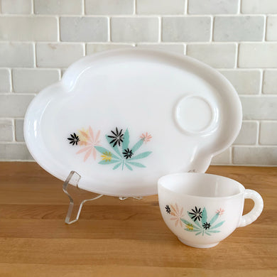 This delightful vintage mid-century era Atomic Flower eight piece milk glass snack plate and cup set captures the perfect balance between classic style and sophistication. The plates are offset oval shaped and both plate and cup feature a sweet pattern of florals in shades of turquoise, pink, yellow and black. Crafted by Federal Glass, USA, circa 1950s. New old stock in original box. In like-new vintage condition, no chips, cracks or wear.

Snack plates measure 7x10 inches Cups measure 3 1/4x2 1/2 inches