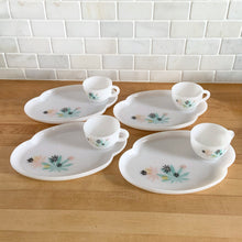 Load image into Gallery viewer, This delightful vintage mid-century era Atomic Flower eight piece milk glass snack plate and cup set captures the perfect balance between classic style and sophistication. The plates are offset oval shaped and both plate and cup feature a sweet pattern of florals in shades of turquoise, pink, yellow and black. Crafted by Federal Glass, USA, circa 1950s. New old stock in original box. In like-new vintage condition, no chips, cracks or wear.

Snack plates measure 7x10 inches Cups measure 3 1/4x2 1/2 inches
