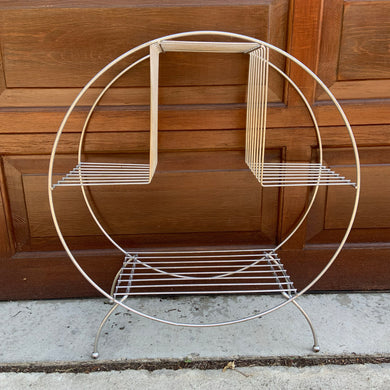Vintage mid-century Art Deco wire circular hoop plant stand in silver with ball feet. Perfect for displaying plants, books and decor. Add atomic flair to your indoor or outdoor decor with this piece crafted in the 1950s.  In excellent vintage condition with age related wear.   Measures 24 x 10 x 27 inches