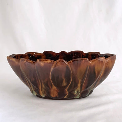 Vintage oval shaped redware pottery planter, finished with Aurora Borealis drip glaze in tones of brown, toffee and green on a lily pattern. Produced by CCC Pottery, Canada, circa 1960s.   In excellent condition, free from cracks/repairs. A couple of minor flea bites to the rim which aren't too noticeable thanks to the colour of the redware.  Measures 8 3 1/8 x 3 1/8 inches