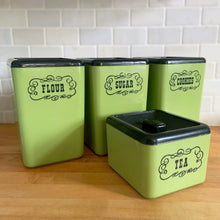 Load image into Gallery viewer, Vintage set of four retro avocado green plastic kitchen canisters topped with brown lids. Each has funky retro deboosed typography in brown. Includes flour, sugar, cookies and tea. Crafted by Beacon Plastics, Canada, 1970s. Add these beauties to retro-fy your kitchen countertop!

In great vintage condition. These canisters appear to be well cared for, with age appropriate wear to the plastic. Maker&#39;s mark on the bottom.
