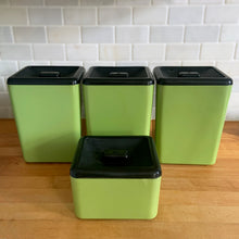 Load image into Gallery viewer, Vintage set of four retro avocado green plastic kitchen canisters topped with brown lids. Each has funky retro deboosed typography in brown. Includes flour, sugar, cookies and tea. Crafted by Beacon Plastics, Canada, 1970s. Add these beauties to retro-fy your kitchen countertop!

In great vintage condition. These canisters appear to be well cared for, with age appropriate wear to the plastic. Maker&#39;s mark on the bottom.

