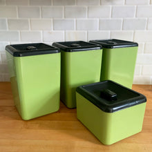 Load image into Gallery viewer, Vintage set of four retro avocado green plastic kitchen canisters topped with brown lids. Each has funky retro deboosed typography in brown. Includes flour, sugar, cookies and tea. Crafted by Beacon Plastics, Canada, 1970s. Add these beauties to retro-fy your kitchen countertop!

In great vintage condition. These canisters appear to be well cared for, with age appropriate wear to the plastic. Maker&#39;s mark on the bottom.
