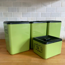 Load image into Gallery viewer, Vintage set of four retro avocado green plastic kitchen canisters topped with brown lids. Each has funky retro deboosed typography in brown. Includes flour, sugar, cookies and tea. Crafted by Beacon Plastics, Canada, 1970s. Add these beauties to retro-fy your kitchen countertop!

In great vintage condition. These canisters appear to be well cared for, with age appropriate wear to the plastic. Maker&#39;s mark on the bottom.
