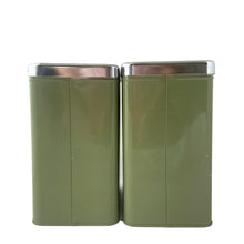 Load image into Gallery viewer, Vintage set of four avocado green retro kitchen canisters topped with chrome lids and green knobs. Each has period style typography in green plastic medallion with a silver letter to represent flour, sugar, coffee and tea. EKCO, Canada, 1970s. Add these beauties to retrofy your countertop! Great vintage condition. Canisters appear to be well cared for, with age appropriate wear to the paint mainly on the Sugar and Flour canisters. Stamped on the bottom with Made in Canada.
