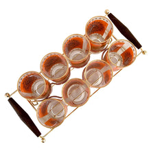 Load image into Gallery viewer, Overhead view of six vintage 1960s Jeannette Glass Celestial Aztec Sun highball glasses showing orange geometric sunburst patterns with 22K gold accents
