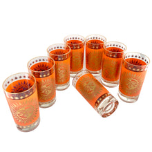 Load image into Gallery viewer, Set of eight vintage Jeannette Glass Celestial Aztec Sun highball glasses arranged showing vibrant orange color and 22K gold geometric patterns, 1960s atomic age barware
