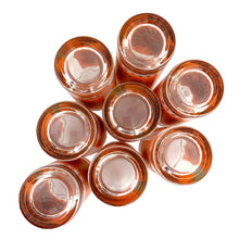 Load image into Gallery viewer, Bottom view of eight vintage 1960s Jeannette Glass Celestial Aztec Sun highball glasses showing orange geometric sunburst patterns with 22K gold accents
