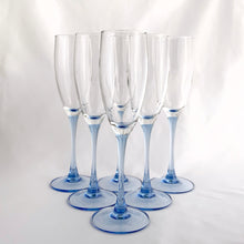 Load image into Gallery viewer, Set of six, delightful vintage Luminarc "Azur" pale blue stemmed champagne flute glasses. Crafted by Cristal d'Arques-Durand, France, between 1991 - 2006. The prettiest glass for any special occasion or to ring in the New Year!  In excellent condition, free from chips/cracks.  Measures 2 3/4 x 8 5/8 inches
