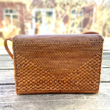 Load image into Gallery viewer, Lovely lightweight natural eastern Bali Ata Grass cross-body purse with loop closure, leather strap and cotton lining. Handcrafted by artisans using time-honoured techniques for Maker&#39;s Supply in Indonesia. Perfect for spring and summer, it adds a touch of casual sophistication to any feminine wardrobe.

The lining may have a water stain, but otherwise the purse is like-new and includes the original tags.

Measures 8 3/4 x 3 1/4 x 6 inches (28 inches with strap)
