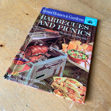 Load image into Gallery viewer, Better Homes and Gardens is known for its fabulous cookbooks. This hardcover cookbook focuses on barbeque and picnic inspired recipes. Its 61 pages are filled with amazing  recipes along with many colour photographs. Originally published by Meredith Corporation, USA, 1963. This is the first edition.   In great vintage condition with normal age-related yellowing.   
