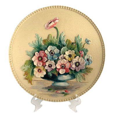 This exquisite vintage round Barbola wall plaque, adorned with a still life of anemone flowers in a blue vase set against a creamy backdrop, this charming artwork is signed by its talented artist, L. Braithwaite, and dates back to the 1930s. Bring a touch of cottage charm to your decor with this stunning piece. In good vintage condition. Some cracking present commensurate with age, see photos. Measures 11 3/4 inches