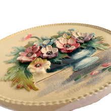 Load image into Gallery viewer, This exquisite vintage round Barbola wall plaque, adorned with a still life of anemone flowers in a blue vase set against a creamy backdrop, this charming artwork is signed by its talented artist, L. Braithwaite, and dates back to the 1930s. Bring a touch of cottage charm to your decor with this stunning piece. In good vintage condition. Some cracking present commensurate with age, see photos. Measures 11 3/4 inches
