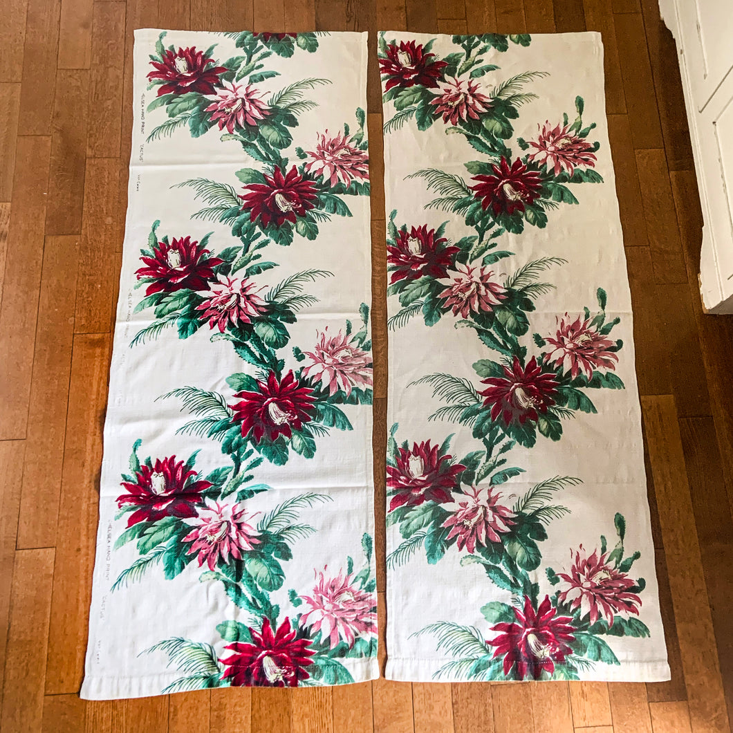 Brighten up your living space with this pair of mid-century barkcloth fabric curtain panels. The ecru backdrop is adorned with bright pink and cherry red floral and green leaf accents for a vivid, cheerful look. The perfect way to add vintage-style to your patio doors and windows.  In excellent condition, free from tears.  Each panel measures 23 1/2 x 64 inches