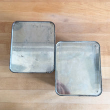 Load image into Gallery viewer, Overhead view of two vintage Lincoln BeautyWare chrome canisters, smooth steel with patina
