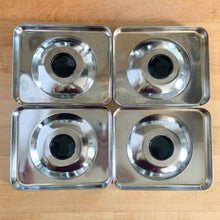 Load image into Gallery viewer, Overhead flat-lay of all four vintage BeautyWare chrome canister lid interiors with black bakelite knobs, Licoln Metal Products, 1940s USA
