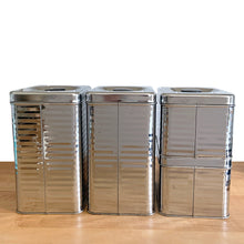 Load image into Gallery viewer, Rear view of Vintage Lincoln BeautyWare 4-piece chrome kitchen canister set, embossed Flour Sugar Coffee Tea lettering, ribbed steel, 1940s USA
