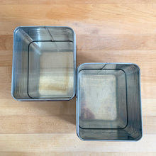 Load image into Gallery viewer, Overhead view of vintage Lincoln BeautyWare chrome kitchen canisters showing ribbed steel interior, small pair
