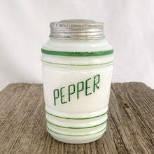 Load image into Gallery viewer, Vintage art deco beehive green striped milk glass pepper shaker featuring the word &quot;PEPPER&quot; in green. Crafted by Hazel-Atlas Glass, USA, 1930s. This highly collectible piece of depression glass will make a great addition to your tableware and kitchen decor!  In great vintage condition, no chips to the glass, minor wear to the paint and lid.  Measures 2 5/8 x 4 3/8 inches
