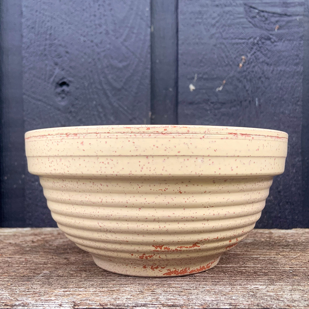 Vintage beige beehive ribbed redware mixing bowl in creamy beige with red speckles. Marked Germany. Perfect for everyday use or add this piece to your kitchen decor.

In vintage condition showing wear to the glaze no chips/cracks/repairs. Marked Germany.


Measures 6 5/8 x 3 1/4 inches