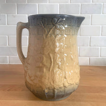 Load image into Gallery viewer, Vintage art deco gloss beige blue fade ceramic yellow ware pitcher featuring climbing roses on a trellis pattern. Crafted by McCoy Pottery, USA, 1920s. A beautiful piece to add to your art pottery collection!

In excellent condition, no chips/cracks/repairs, age-related crazing. Typical manufacturing glaze pops. Unmarked.

Measures 5 1/4 x 7 7/8 inches
