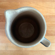 Load image into Gallery viewer, Vintage art deco gloss beige blue fade ceramic yellow ware pitcher featuring climbing roses on a trellis pattern. Crafted by McCoy Pottery, USA, 1920s. A beautiful piece to add to your art pottery collection!

In excellent condition, no chips/cracks/repairs, age-related crazing. Typical manufacturing glaze pops. Unmarked.

Measures 7 x 7 7/8 inches incl. handle
