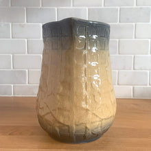 Load image into Gallery viewer, Vintage art deco gloss beige blue fade ceramic yellow ware pitcher featuring climbing roses on a trellis pattern. Crafted by McCoy Pottery, USA, 1920s. A beautiful piece to add to your art pottery collection!

In excellent condition, no chips/cracks/repairs, age-related crazing. Typical manufacturing glaze pops. Unmarked.

Measures 5 1/4 x 7 7/8 inches

