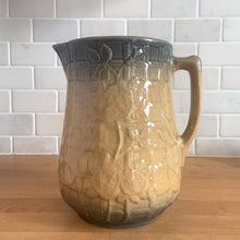 Load image into Gallery viewer, Vintage art deco gloss beige blue fade ceramic yellow ware pitcher featuring climbing roses on a trellis pattern. Crafted by McCoy Pottery, USA, 1920s. A beautiful piece to add to your art pottery collection!

In excellent condition, no chips/cracks/repairs, age-related crazing. Typical manufacturing glaze pops. Unmarked.

Measures 5 1/4 x 7 7/8 inches
