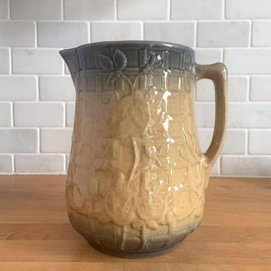Vintage art deco gloss beige blue fade ceramic yellow ware pitcher featuring climbing roses on a trellis pattern. Crafted by McCoy Pottery, USA, 1920s. A beautiful piece to add to your art pottery collection!

In excellent condition, no chips/cracks/repairs, age-related crazing. Typical manufacturing glaze pops. Unmarked.

Measures 5 1/4 x 7 7/8 inches