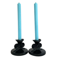 Load image into Gallery viewer, Hard-to-find pair of vintage black amethyst glass single lite candle holders, pattern 2395, featuring figural scrolls. Crafted by Fostoria Glass, USA, 1929 - 1939. These are perfect for long or short taper candles and will make a spooktacular accent for your Halloween decor or elegant tableware display!

In excellent condition, no chips.

Measures 4 1/2 x 3 1/4 inches
