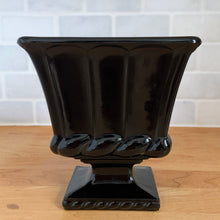 Load image into Gallery viewer, LE Smith black amethyst glass pedestal planter, straight-on front view showing full fluted body, prominent rope-twist collar, and square base with beaded edge detail on wood surface
