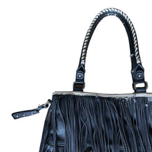 Load image into Gallery viewer, Vintage boho style black faux leather purse with fringe detail, tan interior with one zippered and two open pockets, snap closure. Crafted by Steve Madden.

In as found vintage condition with overall wear, interior is stained, see photos.

Measurements with handles 13 x 28 inches

Measurements without handles 13 x 16 1/2 inches

