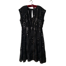 Load image into Gallery viewer, Classic sleeveless black sequined cocktail dress with V neck, split back, flared skirt, size 12. Dress and lining are 100% polyester. RW &amp; CO.

In excellent condition, no tears/stains. Hand wash in cold, hang to dry.

Size 12

Measurements
Shoulders 16 inches
Bust 23 inches
Waist 16 1/2
Hip 22 inches
Length 44 inches
