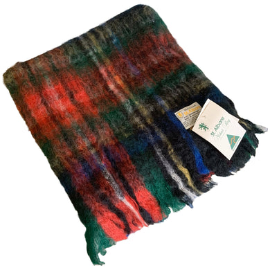 New old stock vintage Black Stewart tartan plaid mohair throw with fringe. Crafted by Holyrood St. Albans, Australia, 1950s. This super soft cozy throw would make a wonderful accent to any home's decor.

In new condition in original bag. Never used with tags. Purchased from original owner.

Measures 48 x 72 inches