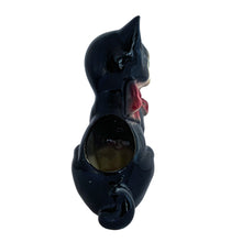 Load image into Gallery viewer, Adorable vintage mid-century black tuxedo cat sporting a pink bow ceramic planter. Crafted by Royal Copley, England, circa 1950. Use this sweet planter to enhance your home decor with your favourite plant. Easily repurpose to hold make-up brushes or office supplies. In great used vintage condition, free from chips/cracks/repairs. There is an occlusion in the ceramic and a bump in the glaze, see photos. The cat measures approximately 5 x 8 inches
