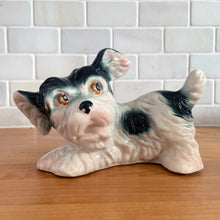 Load image into Gallery viewer, Vintage mid-century hand painted black and white playful Terrier puppy dog ceramic figurine. Crafted in Japan. Add some kitschy cuteness to your life!

In good vintage condition, very minor paint loss to the eyes, no chips/cracks/repairs, age-related crazing. Unmarked.

Measures 6 1/2 x 3 x 4 1/4 inches
