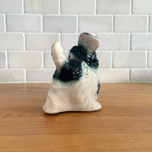 Load image into Gallery viewer, Vintage mid-century hand painted black and white playful Terrier puppy dog ceramic figurine. Crafted in Japan. Add some kitschy cuteness to your life!

In good vintage condition, very minor paint loss to the eyes, no chips/cracks/repairs, age-related crazing. Unmarked.

Measures 6 1/2 x 3 x 4 1/4 inches
