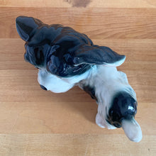 Load image into Gallery viewer, Vintage mid-century hand painted black and white playful Terrier puppy dog ceramic figurine. Crafted in Japan. Add some kitschy cuteness to your life!

In good vintage condition, very minor paint loss to the eyes, no chips/cracks/repairs, age-related crazing. Unmarked.

Measures 6 1/2 x 3 x 4 1/4 inches
