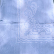 Load image into Gallery viewer, We are in love with this vintage blue-on-blue damask Belgian linen tablecloth featuring a two scalloped rectangles border with a botanical scrolling pattern. The fabric is in excellent condition and would make any table look stunning!  Measures 60&quot; x 96&quot;

