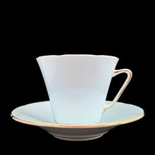 Load image into Gallery viewer, This lovely vintage art deco style bone china teacup and saucer features a pale blue exterior and gold gilt details with subtle scalloped rims. The cup&#39;s white interior and centre of the saucer, each display a hand painted bouquet of pink roses and colourful flowers. Crafted by Royal Grafton, England, 1950s. A lovely way to enjoy a cuppa tea!

In excellent condition, no chips, cracks or repairs. Maker&#39;s mark on the bottom.

Teacup measures 3 1/2 x 3 inches. Saucer measures 5 3/8 inches
