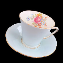 Load image into Gallery viewer, This lovely vintage art deco style bone china teacup and saucer features a pale blue exterior and gold gilt details with subtle scalloped rims. The cup&#39;s white interior and centre of the saucer, each display a hand painted bouquet of pink roses and colourful flowers. Crafted by Royal Grafton, England, 1950s. A lovely way to enjoy a cuppa tea!

In excellent condition, no chips, cracks or repairs. Maker&#39;s mark on the bottom.

Teacup measures 3 1/2 x 3 inches. Saucer measures 5 3/8 inches
