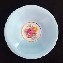 Load image into Gallery viewer, This lovely vintage art deco style bone china teacup and saucer features a pale blue exterior and gold gilt details with subtle scalloped rims. The cup&#39;s white interior and centre of the saucer, each display a hand painted bouquet of pink roses and colourful flowers. Crafted by Royal Grafton, England, 1950s. A lovely way to enjoy a cuppa tea!

In excellent condition, no chips, cracks or repairs. Maker&#39;s mark on the bottom.

Teacup measures 3 1/2 x 3 inches. Saucer measures 5 3/8 inches
