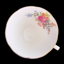 Load image into Gallery viewer, This lovely vintage art deco style bone china teacup and saucer features a pale blue exterior and gold gilt details with subtle scalloped rims. The cup&#39;s white interior and centre of the saucer, each display a hand painted bouquet of pink roses and colourful flowers. Crafted by Royal Grafton, England, 1950s. A lovely way to enjoy a cuppa tea!

In excellent condition, no chips, cracks or repairs. Maker&#39;s mark on the bottom.

Teacup measures 3 1/2 x 3 inches. Saucer measures 5 3/8 inches
