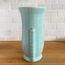 Load image into Gallery viewer, Side view of vintage Brentleigh Ware Art Deco celadon blue gloss glazed ceramic vase, showing ribbed angular handle and curved body profile
