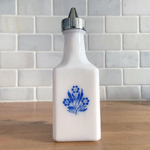 Load image into Gallery viewer, Classic vintage white milk glass vinegar dispenser, featuring blue cornflowers and a plasticized chrome lid. Crafted by Dominion Glass Canada, circa 1970.  In excellent condition&nbsp;with only minor wear to the chrome, the glass is free from chips/cracks.  Measures 2 x 2 x 6 inches
