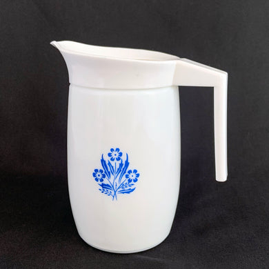 Classic vintage white milk glass creamer pitcher featuring blue cornflowers with a white plastic collar/handle. Produced by Van Pak, Canada, circa 1970s.  In excellent condition free from chips/cracks.  Creamer measures 2 3/4 x 5 inches   