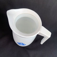 Load image into Gallery viewer, Classic vintage white milk glass creamer pitcher featuring blue cornflowers with a white plastic collar/handle. Produced by Van Pak, Canada, circa 1970s.  In excellent condition free from chips/cracks.  Creamer measures 2 3/4 x 5 inches   
