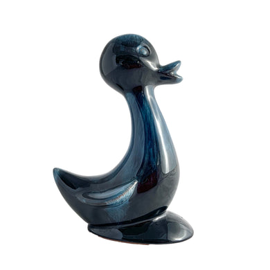 As the saying goes, good things come in small packages! This sweet vintage redware pottery figurine of a duck is finished in blue drip glaze. Crafted by Blue Mountain Pottery Canada, circa 1970s. This piece would be perfect as an decorative object to add a whimsical pop of colour to any room.  In excellent condition, free from chips or cracks.  Measures 5 1/2 inches tall